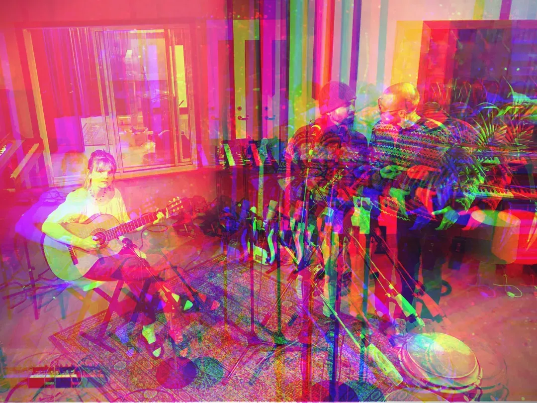 Färgsprakande, psykedelisk bild av en gitarrist i studion.